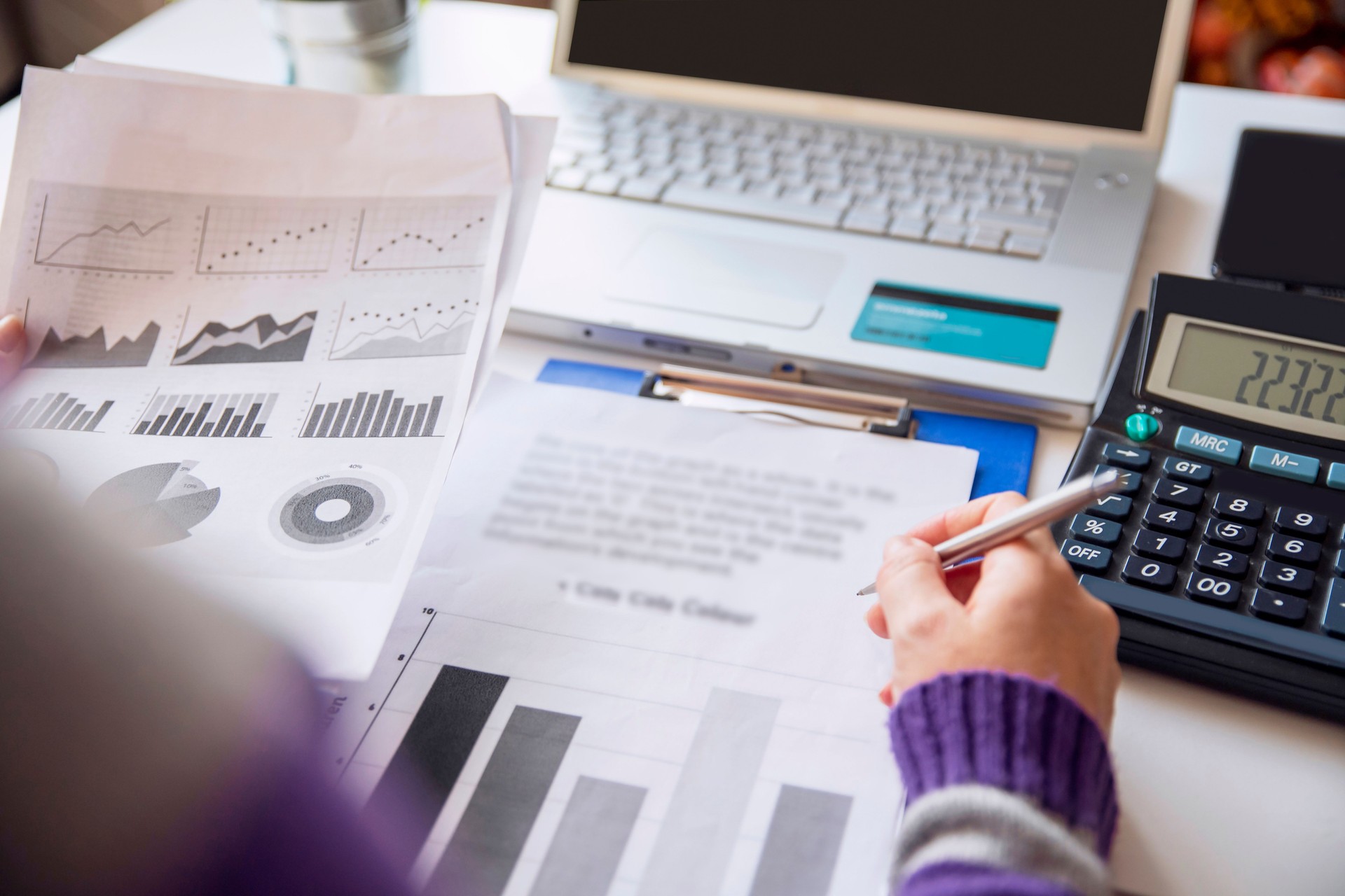 Analyzing chart of economic budget in her small business