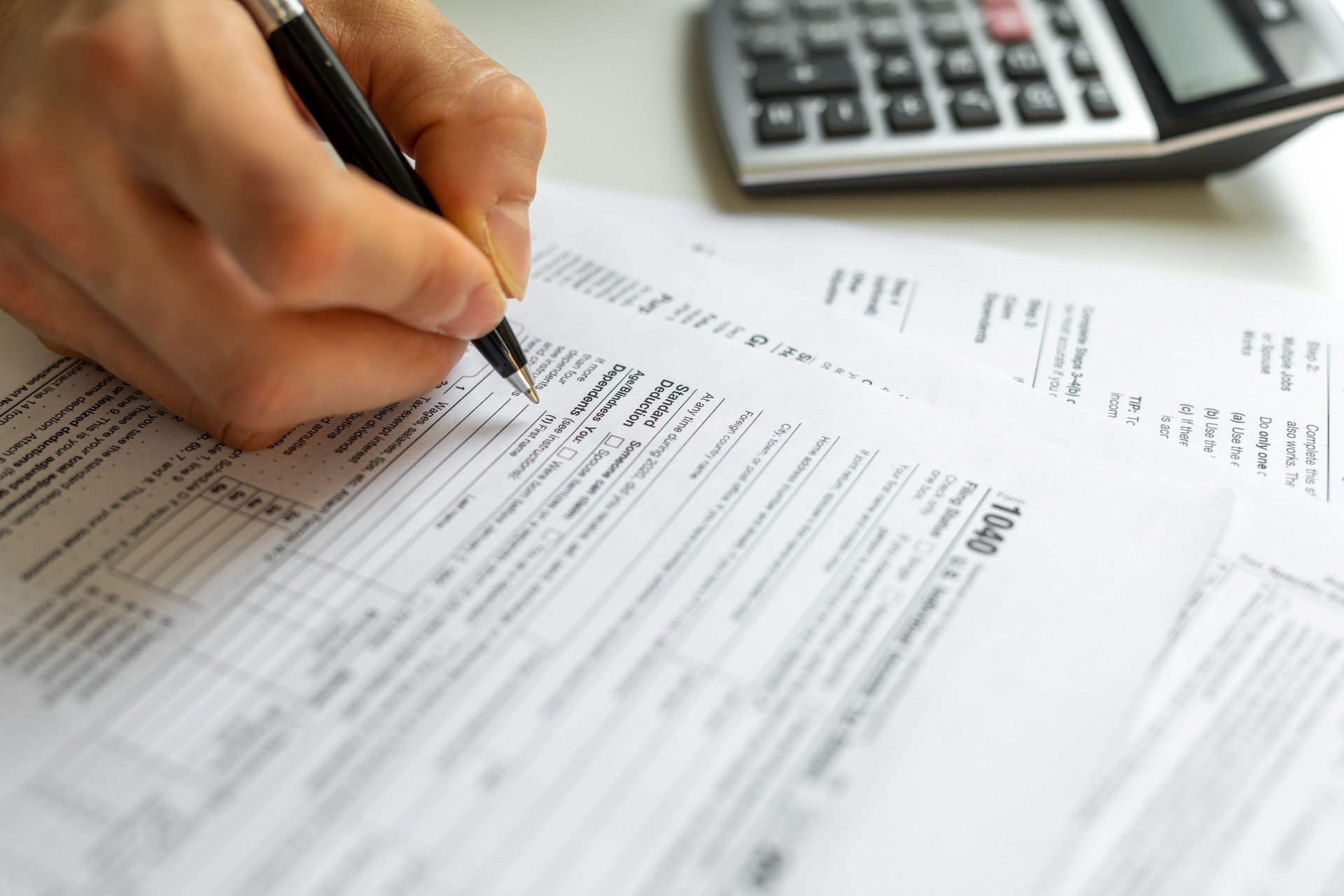 Man filling form of individual income tax return